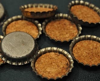Metal crown corks, bottle caps, lined on the inside by natural cork disks. Crown corks with cork inserts widely used during the'40's and '50's.